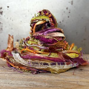 mango tree fringe effects™  handmade fiber bundle 21 yards . berry gold green art yarn sampler