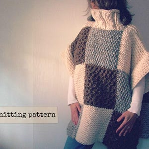 May include: A knitted poncho with a patchwork design in beige, brown, and gray. The poncho has a high neck and a loose fit.