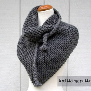 May include: A grey knitted cowl with a long, twisted cord. The cowl is draped over a mannequin and has a triangular shape. The text "knitting pattern" is visible at the bottom of the image.