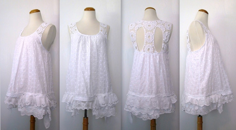 May include: White sleeveless dress with a lace overlay and a scalloped hem. The dress has a round neckline and a gathered bodice. The back of the dress features a cutout design.