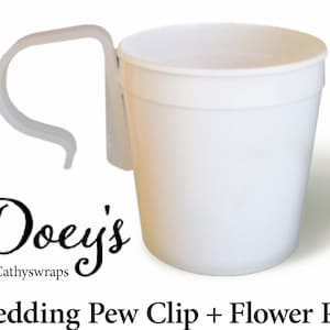 May include: White plastic flower pot with a clear plastic clip handle. The pot is designed to be attached to a pew or chair. The text "Doey's By Cathyswraps Wedding Pew Clip + Flower Pot" is printed below the image.