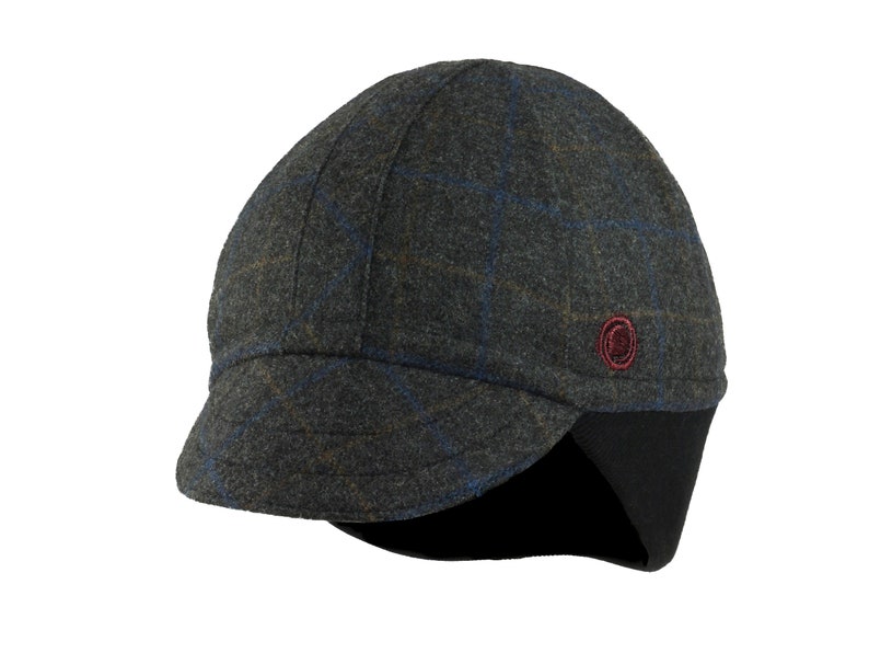 Gregario Winter Cap handmade with short brim by Red Dots Cycling. 100% Italian wool cashmere fabric. Colors: grey, blue & camel. Black ear flap is double-layered, bamboo cotton ribbed. Red Dots burgundy logo embroidered on side panel.