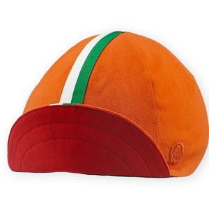 Bilbao Cycling Cap 4 panels short brim Cap handmade by Red Dots Cycling. Cap is all orange linen / cotton with red underbrim. Two ribbons: white and green to bottom of brim. Red Dots logo in orange embroidered on side panel.
