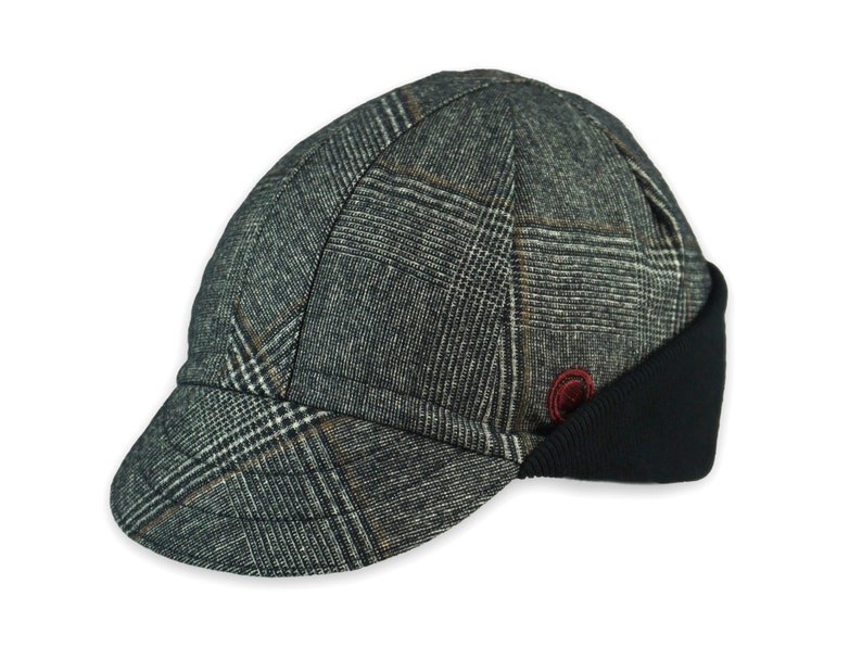 Presta Winter Cap handmade with short brim by Red Dots Cycling. 100% Glen check black/white wool plaid fabric. Black ear flap is double-layered, bamboo cotton ribbed in up position. Red Dots burgundy logo embroidered on side panel.