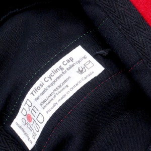 Tifosi Cycling Cap by Red Dots Cycling.
Close-up of our sewn-in label. Including; cap name, fabric content, washing care and sizing.