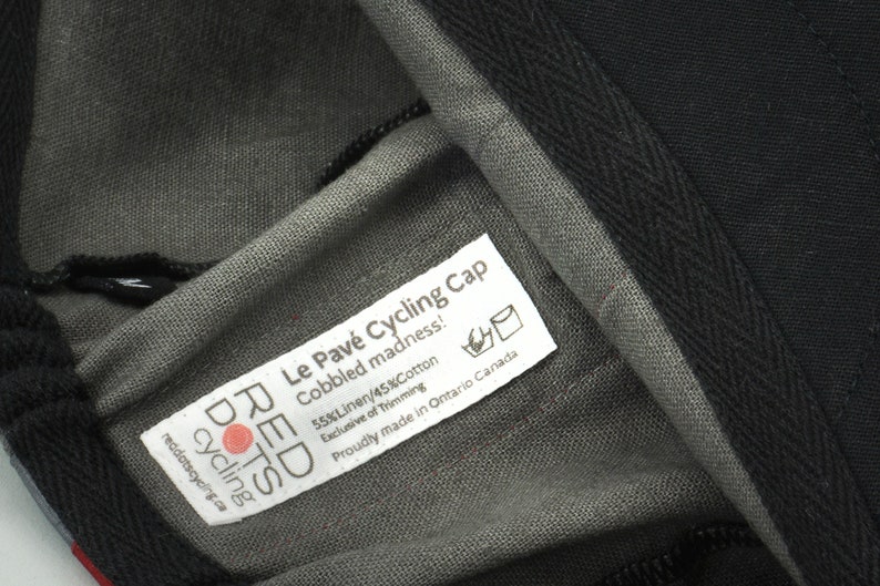 Le Pave Cycling Cap,
Close-up of our sewn-in label. Including; cap name, fabric content, washing care and sizing.