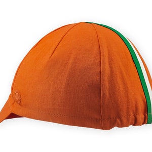 Bilbao Cycling Cap 4 panels short brim Cap handmade by Red Dots Cycling. Cap is all orange linen / cotton with red underbrim. Two ribbons: white and green to bottom of brim. Red Dots logo in orange embroidered on side panel.