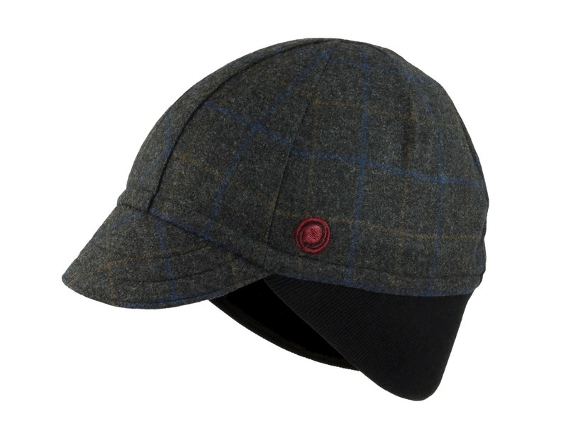 Gregario Winter Cap handmade with short brim by Red Dots Cycling. 100% Italian wool cashmere fabric. Colors: grey, blue & camel. Black ear flap is double-layered, bamboo cotton ribbed. Red Dots burgundy logo embroidered on side panel.