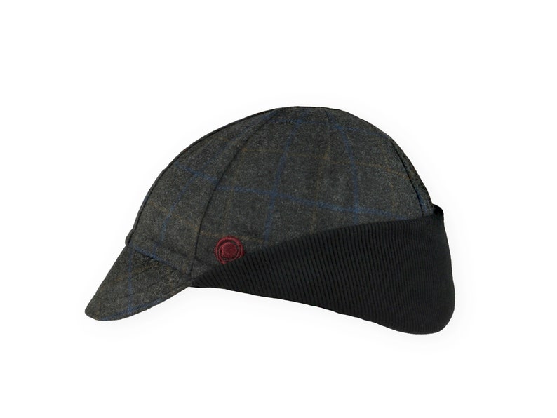 Gregario Winter Cap handmade with short brim by Red Dots Cycling. 100% Italian wool cashmere fabric. Colors: grey, blue & camel. Black ear flap is double-layered, bamboo cotton ribbed in up position. Red Dots burgundy logo embroidered on side panel.