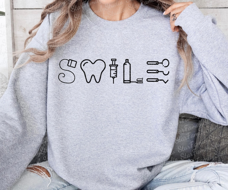 May include: Gray sweatshirt with a black graphic of a tooth, syringe, and dental tools with the word "SWILE" above the graphic.