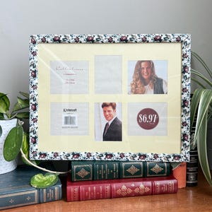 May include: A multi-photo picture frame with a floral pattern border. The frame holds six photos, with two photos visible. The frame is resting on a stack of vintage books. The frame's dimensions are 11 x 14 inches.