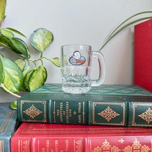 May include: A set of three ceramic mugs with a speckled, matte finish. The mugs are in shades of cream, light gray, and dark gray. Each mug has a simple, minimalist design, perfect for coffee or tea.