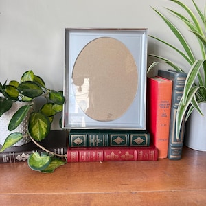 May include: A white ceramic mug with a black handle and the text "But First, Coffee" in a black, handwritten-style font. The mug is on a white surface.