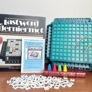 May include: A vintage board game set, "Le Last Word Game," with a teal game board, letter tiles, and a book. The box features the game title in English and French. Includes a "Upwords" game insert. A fun word game for 2-4 players.