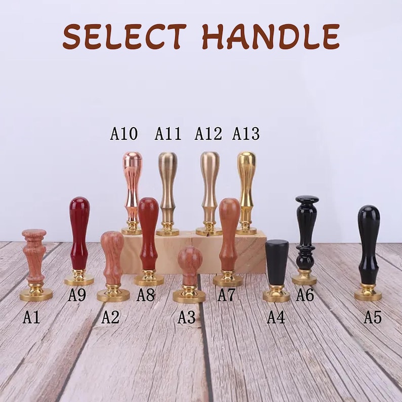 May include: A selection of 13 different wax seal stamp handles. The handles are made of wood and metal and come in a variety of colors, including gold, silver, black, and red. The handles are labeled with letters A1 through A13.  Select Handle.