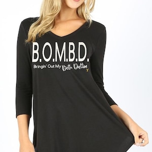 May include: Black long-sleeved shirt with a white graphic that says "B.O.M.B.D. Bringin' Out My Beth Dutton Y".