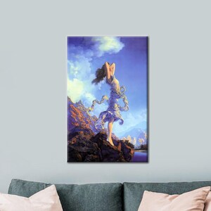 May include: A vertical art print depicting a woman standing on a rocky outcrop, with her arms raised. The artwork features a blue sky with clouds, mountains in the background, and flowing fabric around the woman.