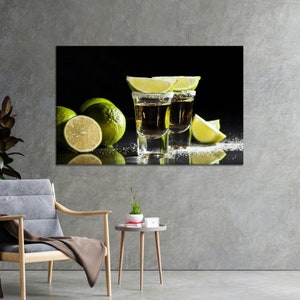 May include: Two shot glasses filled with a golden liquid, rimmed with salt and garnished with lime wedges. The glasses are on a black surface with lime wedges and salt scattered around them.