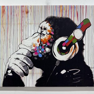May include: A colorful abstract painting of a gorilla wearing headphones. The gorilla is painted in black, white, and shades of blue, pink, and green. The background is a white canvas with colorful vertical stripes.