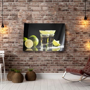 May include: Two shot glasses filled with a dark liquid and garnished with lime wedges. The glasses are on a black surface with lime wedges and sugar crystals scattered around them.