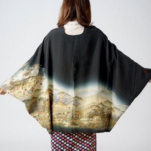 May include: Black kimono with a landscape design on the sleeves and a floral patterned skirt. The kimono features a scenic illustration with mountains and figures, creating a vintage aesthetic.