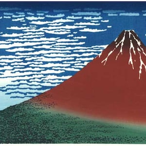 Può includere: Una stampa su legno che rappresenta il Monte Fuji, un vulcano rosso con neve bianca sulla cima, su uno sfondo di cielo blu e nuvole bianche. Il testo giapponese "富嶽三十六景" è visibile nell'angolo in alto a sinistra.