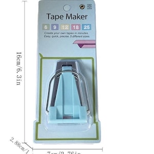 May include: A light blue and silver metal tape maker tool packaged on a card labeled Tape Maker with size options 6, 9, 12, 18, and 25. The packaging indicates a height of 6.3 inches, a width of 2.76 inches, and a depth of 1.13 inches.