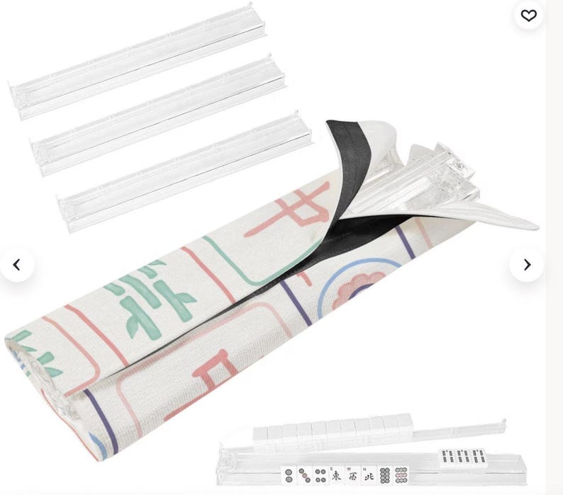 Coordinating Mahjong rack storage bag in a pastel Mahjong tile pattern shown holding clear acrylic Mahjong racks. The image displays four transparent racks, the patterned rack bag with hook-and-loop closure, and a rack loaded with Mahjong tiles.