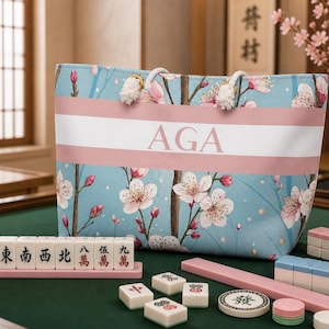 Cherry blossom personalized tote bag used as a mahjong accessory bag on a mahjong table with tiles and racks, showing large storage capacity.