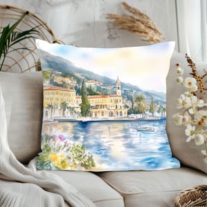 May include: Watercolor painting of a yellow building with a clock tower on a waterfront with a boat in the water. The building is surrounded by palm trees and green foliage. The sky is blue and the water is a light blue.