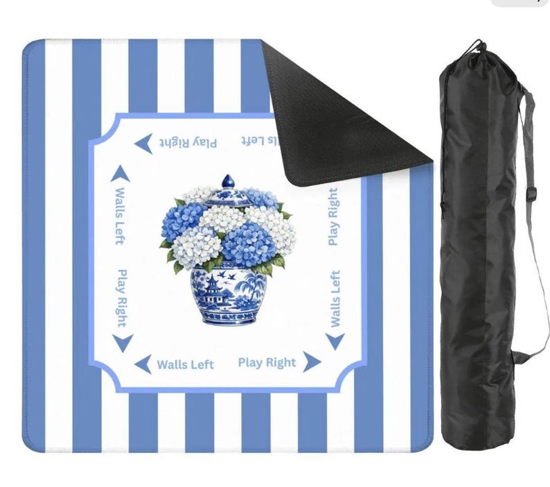Blue and white striped mahjong mat with hydrangea chinoiserie vase design shown with rolled black carrying sleeve on a clean white background.