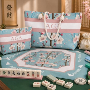 May include: A matching set of a tote bag and a cosmetic bag, both featuring a floral pattern with pink and white accents on a light blue background. The bags have the letters "AGA" on them. A Mahjong set is also visible.