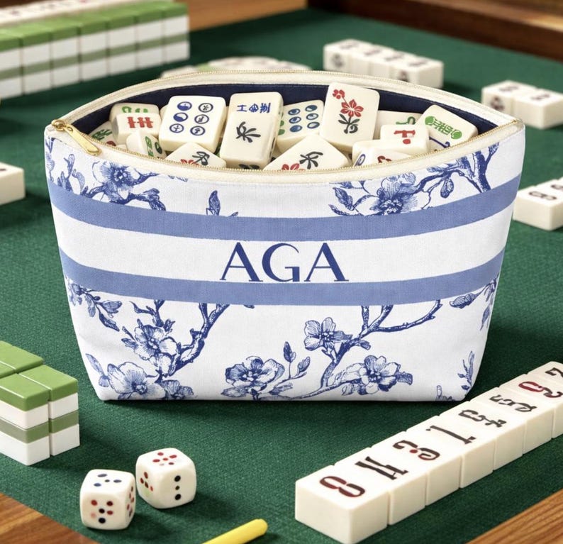 Personalized blue floral toile cosmetic bag with light blue stripe and navy monogram, elegant zipper pouch for makeup or travel essentials.