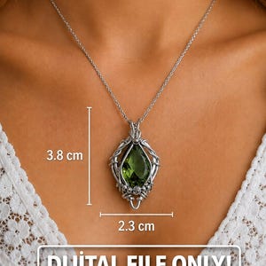 May include: A silver-toned wire-wrapped pendant featuring a pear-shaped olive green gemstone on a thin chain. The pendant measures 3.8 cm in height and 2.3 cm in width. The image includes the text DIJITAL FILE ONLY! PDF, indicating a digital download.