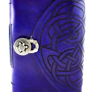 May include: A deep purple leather journal with a Celtic knot design embossed on the cover. The journal features a silver-colored clasp and a stitched spine. The cover has a flap closure.