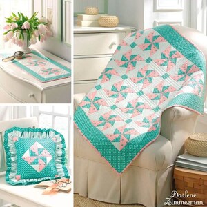 May include: A Simplicity quilting pattern, number 3703, titled "ez quilter's delight" by Darlene Zimmerman. The pattern features a quilt, pillow, and table runner with a pink and teal pinwheel design. The pattern is part of the "ez quilting" line by Wrights.