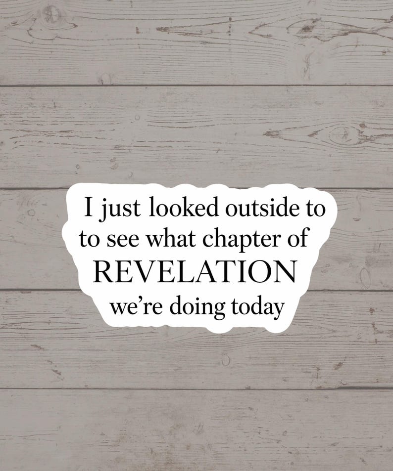 Op de afbeelding: Witte sticker met de tekst "I just looked outside to see what chapter of REVELATION we're doing today" in zwarte letters. De sticker staat op een lichtgrijze houten achtergrond.