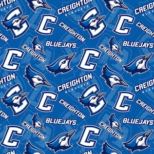 May include: A blue and white repeating pattern featuring the Creighton Bluejays logo. The logo includes a blue jay bird head, the letter "C", and the words "Creighton Bluejays".