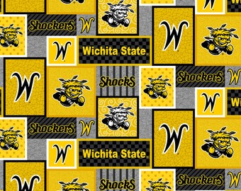 May include: A yellow and black fabric with a repeating pattern of the Wichita State University logo, the letters "W" and "Shockers", and the words "Wichita State".