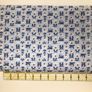 May include: Blue fabric with a repeating pattern of red flowers, white stars, and blue and white train designs.