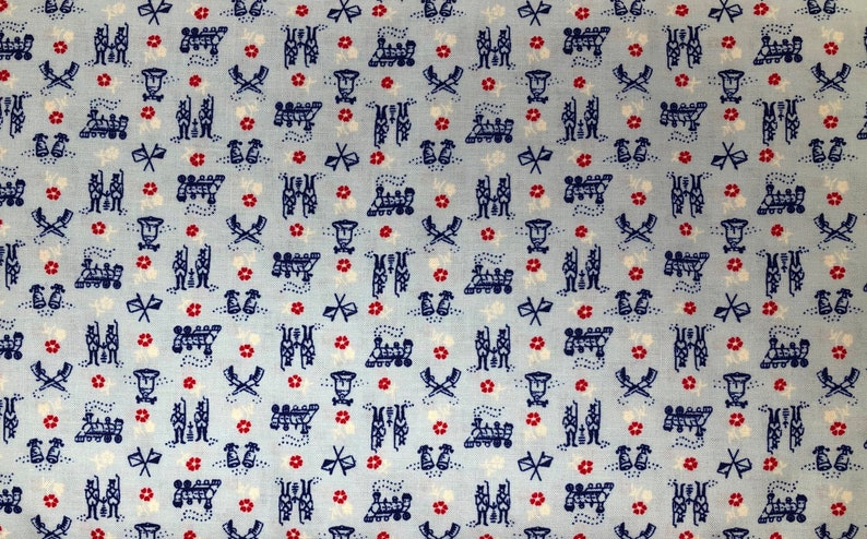 May include: A blue and white fabric with a repeating pattern of small red flowers, musical notes, and a marching band. The fabric has a light blue background.