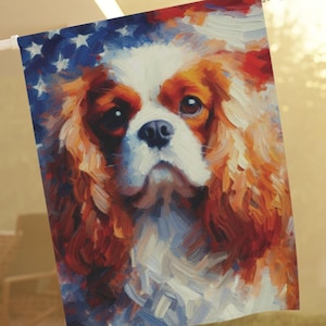 May include: A patriotic garden flag featuring a Cavalier King Charles Spaniel dog with red, white, and blue colors. The dog's face is painted in a stylized, brushstroke style.