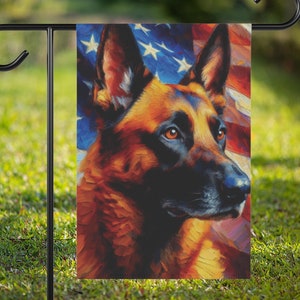 May include: A garden flag depicting a German Shepherd dog with a patriotic theme. The flag shows a portrait of the dog against the backdrop of the American flag. The dog has brown and black fur and is set on a black metal stand.