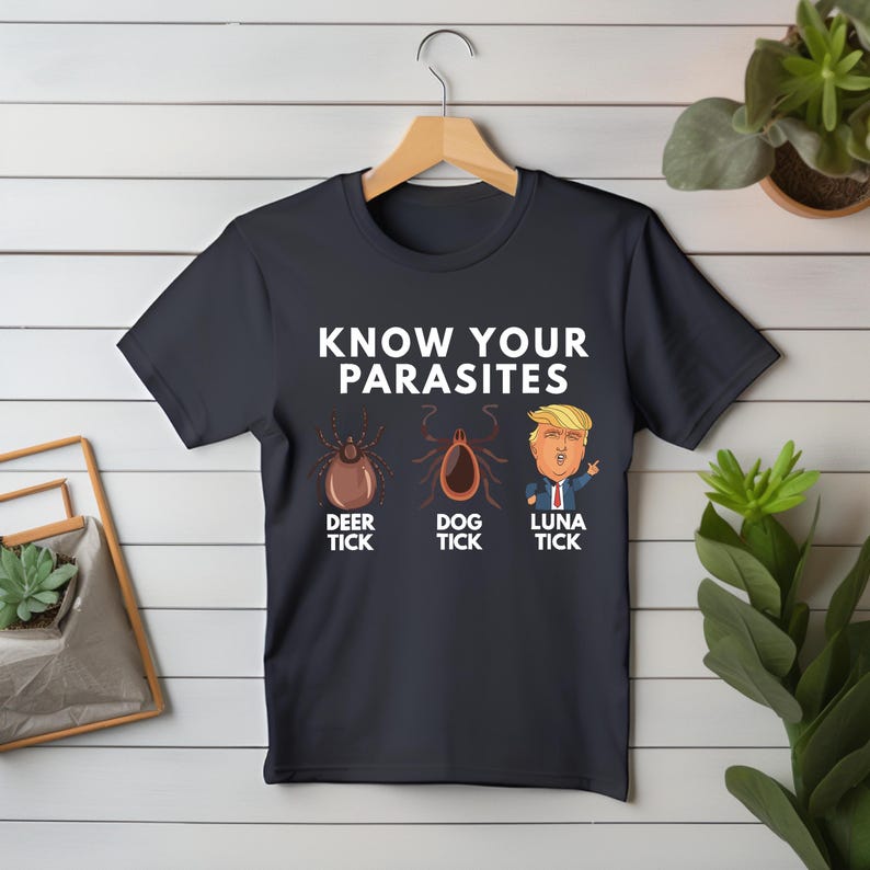 May include: A dark blue t-shirt with the text "KNOW YOUR PARASITES" and three cartoon images of ticks labeled "DEER TICK", "DOG TICK", and "LUNA TICK".