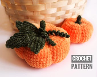May include: Two crocheted pumpkins, one with a green crocheted leaf, on a white surface. The text "CROCHET PATTERN" is visible in the lower right corner of the image.