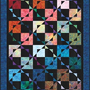 May include: A quilt with a black background and a pattern of colorful triangles. The triangles are arranged in a grid pattern, and each triangle is a different color. The quilt is bordered by a blue fabric with a swirl pattern.