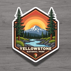 May include: A hexagonal sticker featuring a landscape illustration of Yellowstone National Park. The design includes a snow-capped mountain, a winding blue river, green pine trees, and a sunset sky. The text reads YELLOWSTONE NATIONAL PARK.