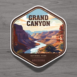 May include: A hexagonal sticker featuring a graphic illustration of the Grand Canyon with a winding river, layered rock formations, and a pale sky. The text reads GRAND CANYON, NATIONAL PARK, and ARIZONA in dark brown lettering against the landscape.