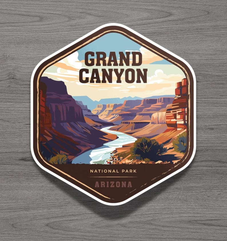 May include: A hexagonal sticker featuring a graphic illustration of the Grand Canyon with a winding river, layered rock formations, and a pale sky. The text reads GRAND CANYON, NATIONAL PARK, and ARIZONA in dark brown lettering against the landscape.