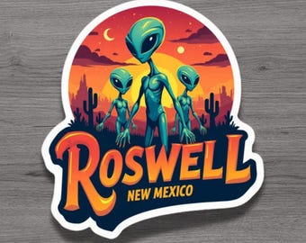 May include: A sticker featuring three teal aliens in front of a sunset over a desert landscape with cacti. The word "Roswell" is in orange and yellow, with "New Mexico" below in white.